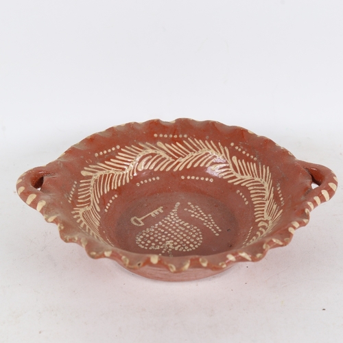 310 - A 19th century 2-handled slip glaze pottery bowl, width 23cm