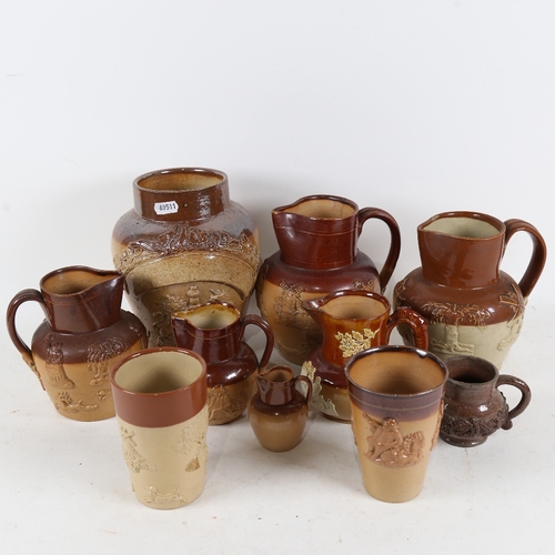 311 - Stoneware jugs and cups, including Royal Doulton salt glazed hunting jug and Harvest jug (10)