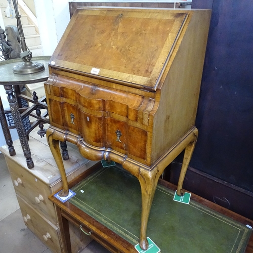 1840 - A crossbanded walnut bureau, with a fitted interior, 2 serpentine-front drawers under, on cabriole l... 