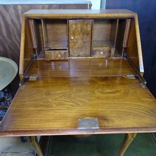 1840 - A crossbanded walnut bureau, with a fitted interior, 2 serpentine-front drawers under, on cabriole l... 