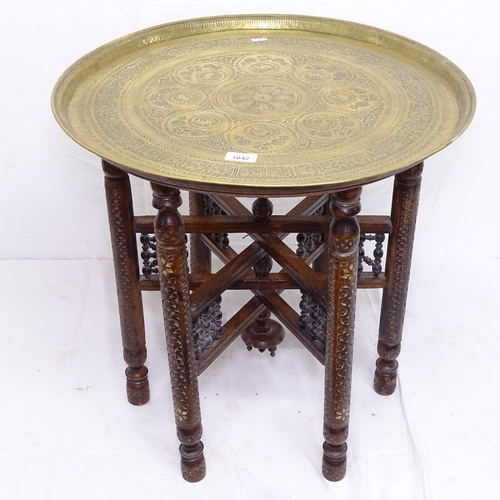 1842 - An Indian engraved brass-top table, on carved and pierced folding base, W58cm, H58cm