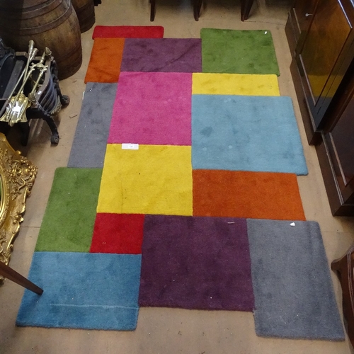 1859 - A multi-coloured geometric design rug, 240cm x 150cm