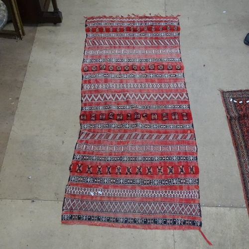 1875 - A red ground Kilim rug, 200cm x 90cm