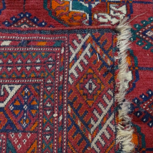 1878 - A red ground Afghan Tekki carpet, with symmetrical pattern, 146cm x 106cm