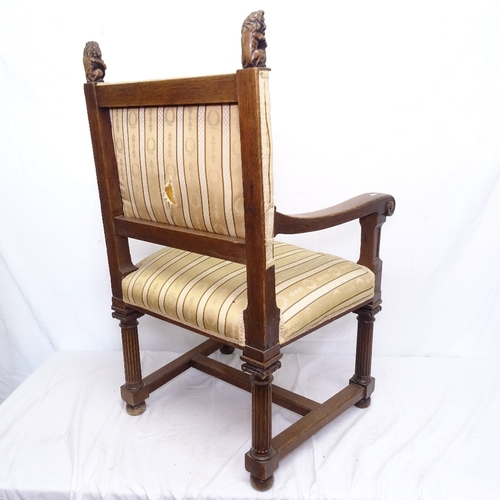 1888 - An Baronial oak elbow chair, with carved rampant lion mounts, silk upholstery on Palladian legs