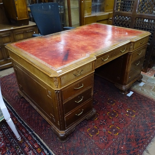 1890 - A mahogany partners' writing desk, having a red leather skiver, and fitted drawers and cupboards, on... 