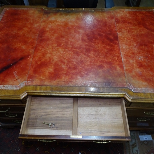 1890 - A mahogany partners' writing desk, having a red leather skiver, and fitted drawers and cupboards, on... 