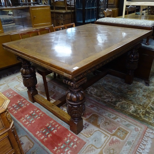 1895 - A large French parquetry-topped oak draw leaf dining table, with carved frieze, acanthus leaf carved... 