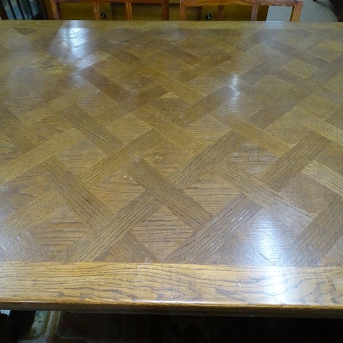 1895 - A large French parquetry-topped oak draw leaf dining table, with carved frieze, acanthus leaf carved... 