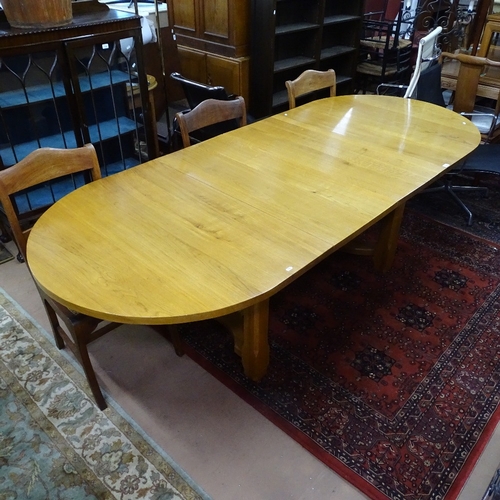 1900 - A modern golden oak bow-end extending dining table, with 2 spare leaves, on a chamfered leg base, L1... 