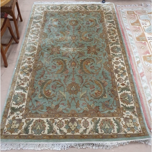 1919 - A green ground Persian style rug, 240cm x 152cm