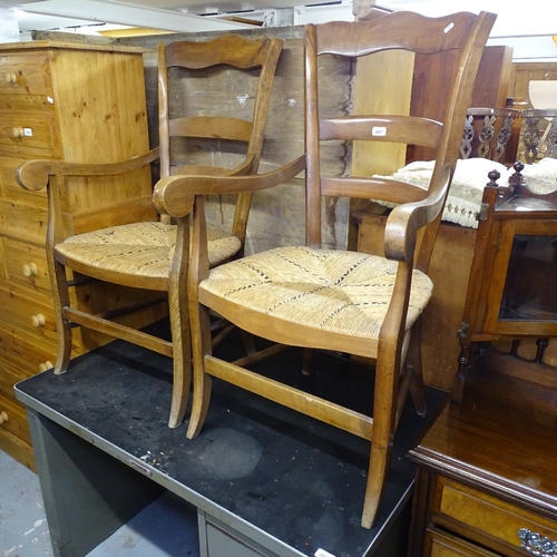 2057 - A pair of French walnut ladder-back rush-seated elbow chairs