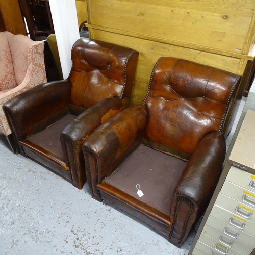 2098 - A pair of early 20th century studded brown leather-upholstered armchairs