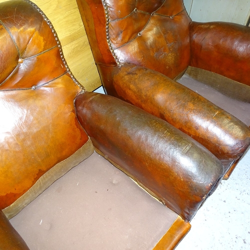 2098 - A pair of early 20th century studded brown leather-upholstered armchairs