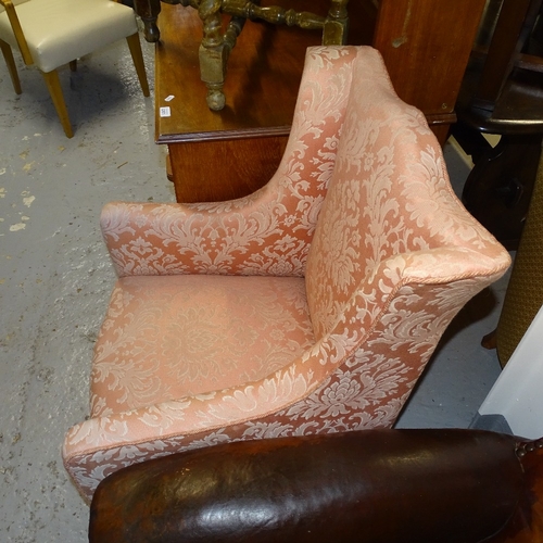 2099 - An Edwardian upholstered wing armchair, on tapered legs