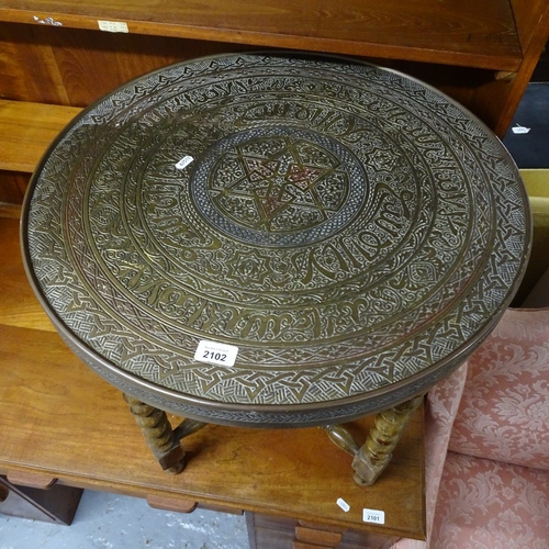 2102 - A Persian brass table-top on folding base, W59cm, H59cm