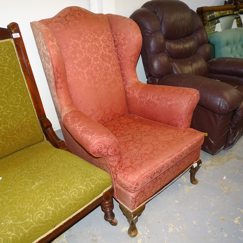 2112 - An Edwardian upholstered wing armchair