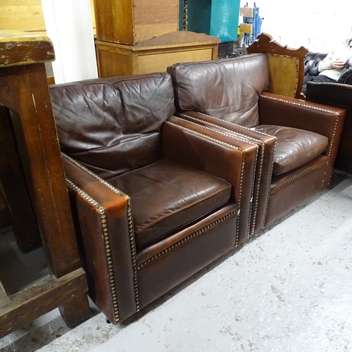 2132 - A pair of studded brown leather-upholstered armchairs