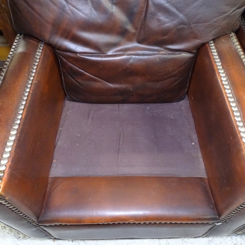 2132 - A pair of studded brown leather-upholstered armchairs