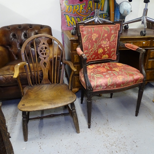 2142 - A 19th century elm-seated wheel-back elbow chair, and an Antique mahogany elbow chair (2)