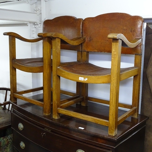 2182 - A pair of early 20th century studded leather-upholstered elbow chairs