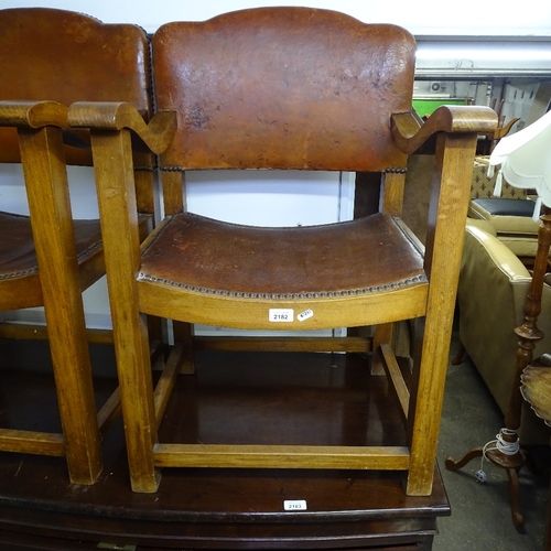 2182 - A pair of early 20th century studded leather-upholstered elbow chairs