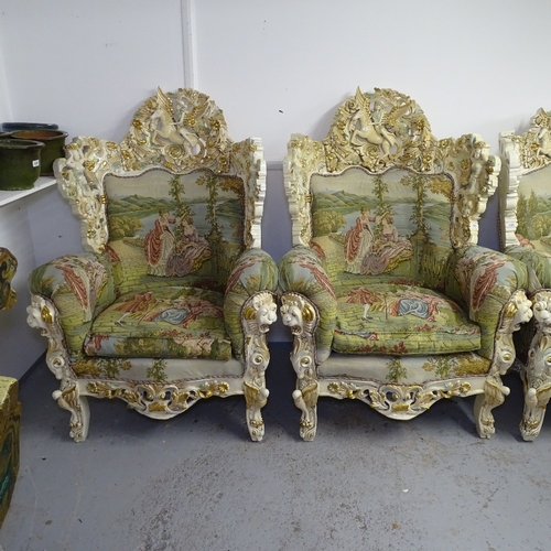 2199 - A pair of matching bespoke made armchairs, with carved winged horse and figure crests, made in Egypt... 