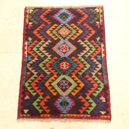 2223 - A red ground Beluchi rug, 114cm x 83cm