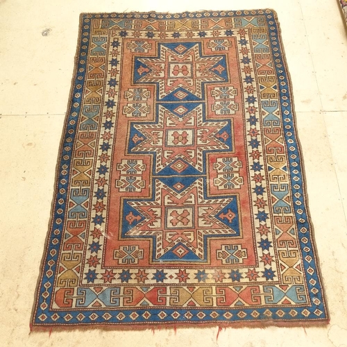 2227 - A red ground Afghan rug with symmetrical pattern, 195cm x 128cm