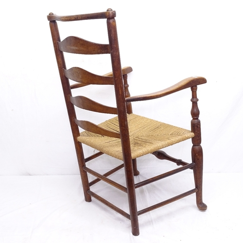 1925 - An Antique ladder-back rush-seated kitchen elbow chair on pad foot