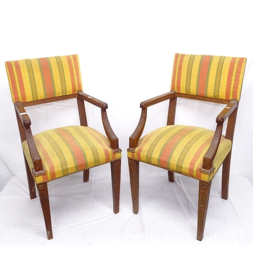 1926 - A pair of French oak elbow chairs, with studded upholstery, on tapered legs