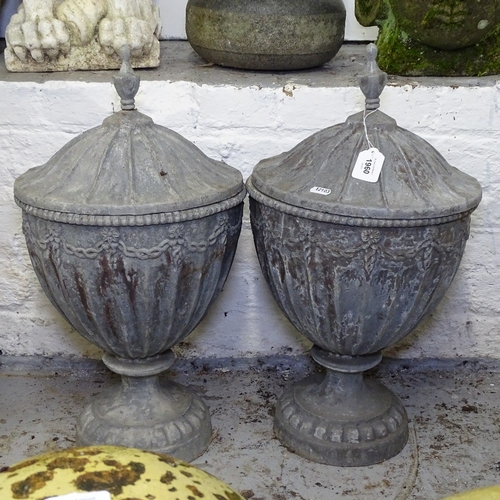 1960 - A pair of embossed lead urns and cover, in Adams style, H55cm