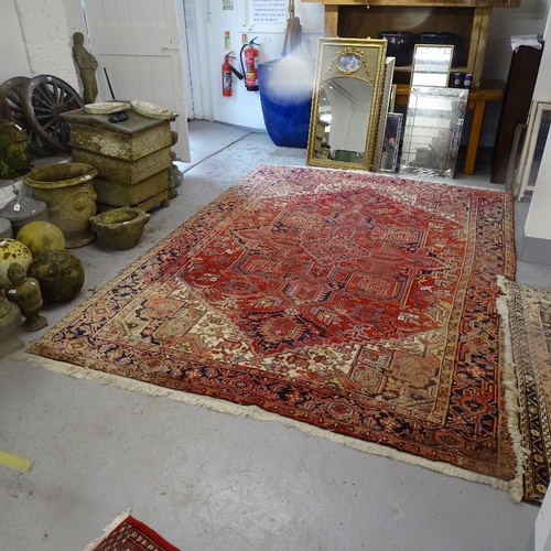 1975 - A red ground Kashan design carpet, with symmetrical lozenge and borders, 330cm x 238cm