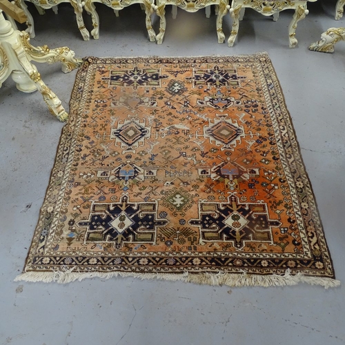 1976 - A red ground Afghan rug, with symmetrical pattern borders, 190cm x 165cm