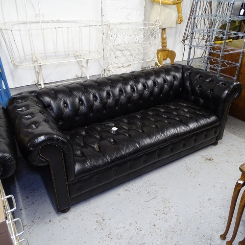 1990 - A black leather button-back rollover arm Chesterfield, L195cm, H70cm, seat height 40cm and depth 50c... 