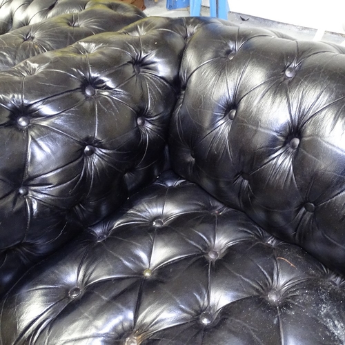 1990 - A black leather button-back rollover arm Chesterfield, L195cm, H70cm, seat height 40cm and depth 50c... 