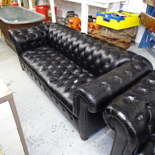 1991 - A black leather button-back rollover arm Chesterfield, L195cm, H70cm, seat height 40cm and depth 50c... 