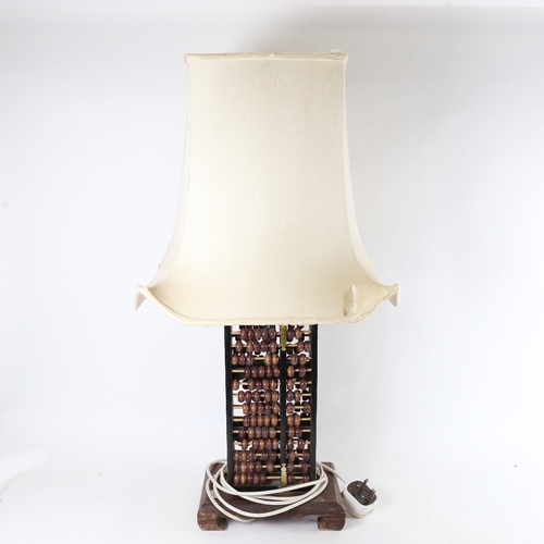 303 - A 2-sided abacus table lamp, height excluding shade 60cm