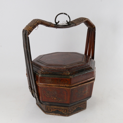 304 - A Chinese elm lacquered food carrier with lid, height 40cm