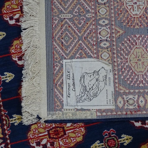 1868 - A Kerman blue ground Iranian silk rug, 225cm x 150cm, with label