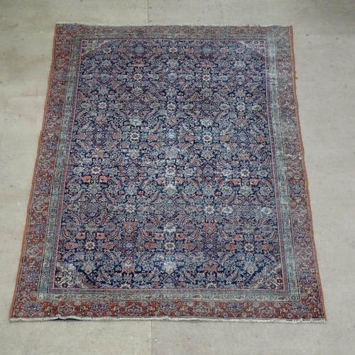 1869 - An Antique red and blue ground Persian rug, with symmetrical lozenge and borders, 180cm x 115cm