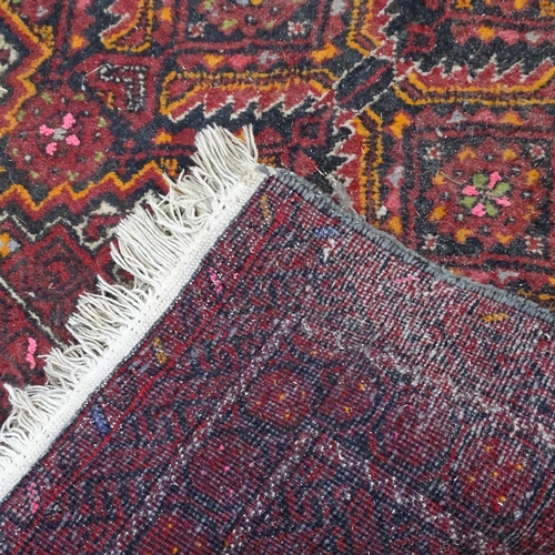 1870 - An Antique red ground Afghan runner, with symmetrical geometric pattern, 215cm x 105cm