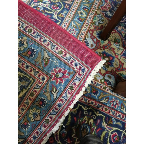 1913 - A large blue and red ground Persian style carpet, with symmetrical border and lozenge, 375cm x 297cm