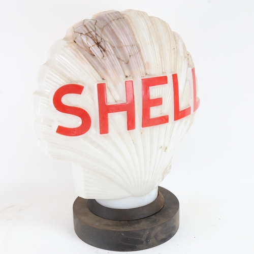 22 - A Vintage Shell Petrol illuminating opaque white glass advertising petrol pump globe lamp, on turned... 