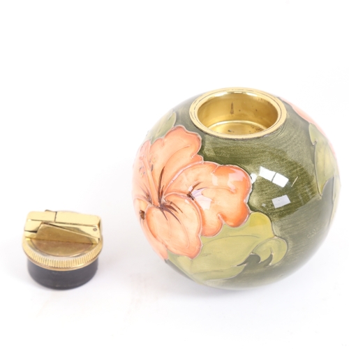 30 - A Moorcroft Hibiscus pattern table lighter, diameter 10.5cm