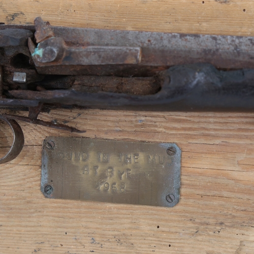 80 - A heavily weathered 18th century percussion pistol, mounted on driftwood board with plaque 