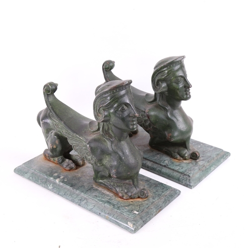 87 - A pair of green painted cast-iron figural fire dogs/door stops, on veined green marble bases, base l... 