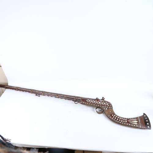 90 - A 19th century Middle Eastern flintlock camel rifle, with allover mother-of-pearl inlaid decoration,... 