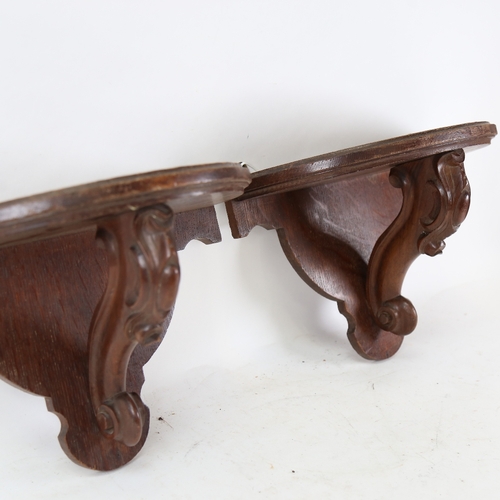 155 - A pair of stained oak wall brackets, height 25cm, width 37cm