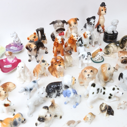 264 - A large quantity of porcelain dog ornaments, including Wade